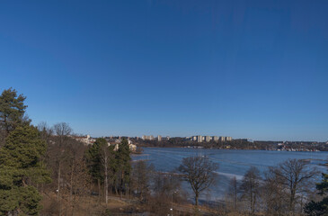 Bridge view over the bay Ulvsundasjön with apartment houses at the waterfront a sunny spring day in Stockholm