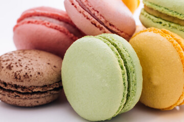 Multicolor macarons , French macaroon, greedy pastry. Close up of Multicolored Macarons Cookies. Food concept.