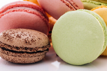 Close up of multicolor macarons French macaroon greedy pastry on white background. Macarons dessert. Food concept