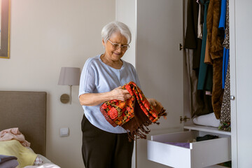 Senior woman tiding up her wardrobe
