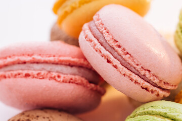 Close up of multicolor macarons French macaroon greedy pastry on white background. Macarons dessert. Food concept