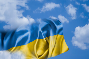 Flag of Ukraine on the background of the sky with clouds