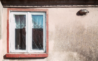 Old wooden window in a weathered building, color toning applied.