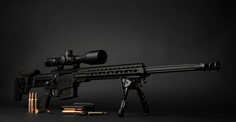 Modern powerful sniper rifle with a telescopic sight mounted on a bipod. Ammo and an additional...