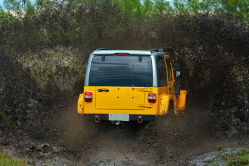 Yellow brazilian off-road sport truck splashing on a muddy puddle road - obrazy, fototapety, plakaty