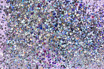 Holographic confetti on pastel pink purple background. Festive concept. High quality photo.