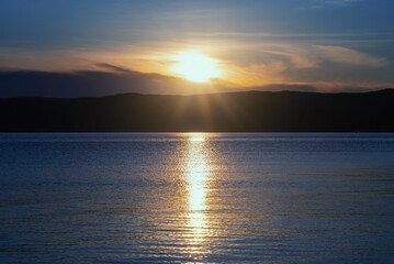 Obraz premium Beautiful sunset on lake Baikal in the summer.