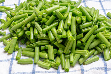 Freshly chopped french beans on a kitchen towel ready to cook