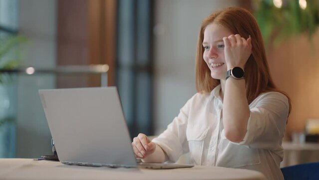 Focused redheaded woman distance teacher online tutor wear headphone conferencing on laptop communicate with student by webcam video call chat explain course help e learning computer education concept