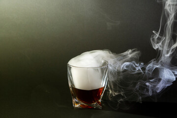 Whiskey drinks isolated on black backdrop. Close up view of a glass of whiskey on a black slate...