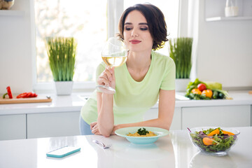 Photo of attractive positive lady hold wine glass prepared domestic pasta free time day kitchen...