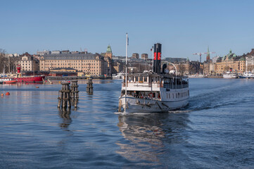Rebuilt old previous steam ship m/s Östanå passing dolphin bollards on a sightseeing tour to the...