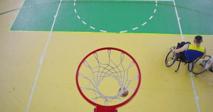 Top view shot of Persons with disabilities playing basketball in the modern hall
