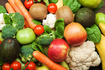 Vegetables and fruits close-up. Cauliflower, carrots, zucchini, tomatoes, broccoli, avocados, bananas, pears, apples. Selective focus.