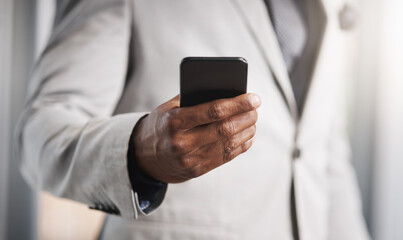 Running business with instant connectivity. Closeup shot of an unrecognizable businessman using a cellphone.