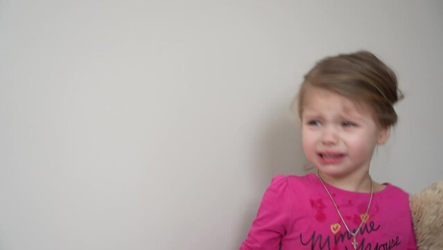 Little angry caucasian kid. Furious capricious toddler kid got upset and sad. Stubborn child bad attitude. Depressed little girl complaining with mom.