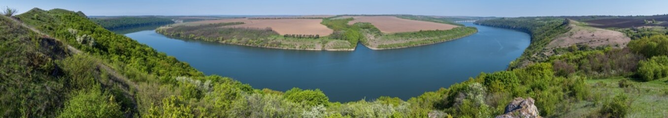Fototapeta premium Amazing spring view on the Dnister River Canyon with picturesque rocks, fields, flowers. This place named Shyshkovi Gorby, Nahoriany, Chernivtsi region, Ukraine.