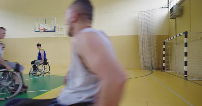 Persons with disabilities playing basketball in the modern hall