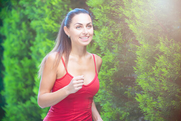 Fitness woman running on forest road