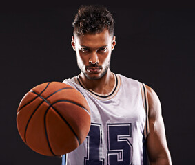 Ready to play. Studio shot of a basketball player against a black background.