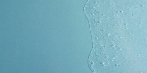Background from cosmetic gel with bubbles,dripping down.Top view,antibacterial liquid surface.Good as background or mockup,large banner.