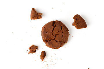 Chocolate cookies with broken and crumbs on white background. Top view.