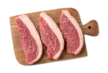 Sliced raw picanha or rump meat over wooden board with salt isolated over white background