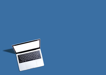 Laptop computer with shadow from above - Flat lay