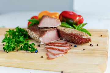 meat on a wooden board with vegetables