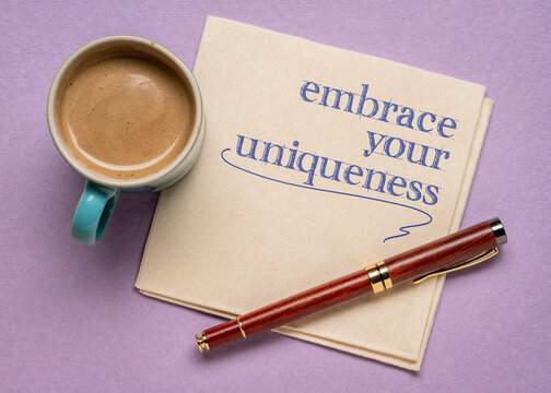 embrace your uniqueness - handwriting on a napkin with a cup of coffee, dare to be different and personal development concept