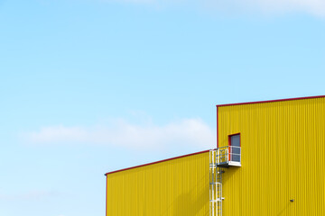 A gray door in a yellow facade 