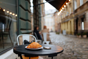 Freshly baked croissant served on cafe terrace