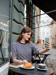 Pleasant woman using cell phone for taking self portrait