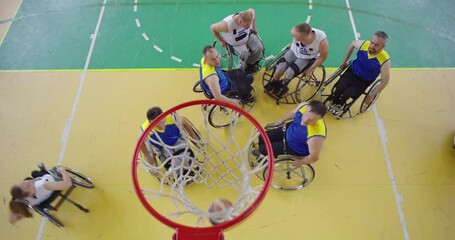 Top view shot of Persons with disabilities playing basketball in the modern hall - Powered by Adobe