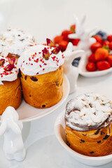 decorated panettones and cruffins on serving plates with rabbits. easter cakes. 