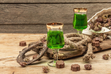 St. Patrick's Day concept. Traditional green cocktail, sweet chocolate in the shape of clover leaves