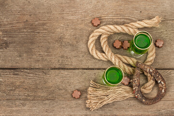 St. Patrick's Day concept. Traditional green cocktail, sweet chocolate in the shape of clover leaves