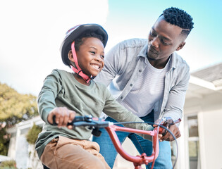 Look at him go. Shot of a father teaching his son to ride a bicycle outdoors.