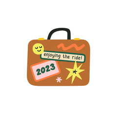 Enjoying the ride in 2023 hand draw lettering. Good year concept. Traveling and trips in 2023. Isolated vector illustration of a suitcase with luggage stickers and tags.