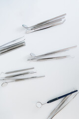 Top view of various organized dentist equipment in a white background