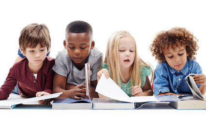 Children who read become adults who think. Studio shot of a group of young friends lying on the floor together while reading books against a white background.
