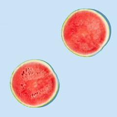 Cut watermelon on blue pastel background