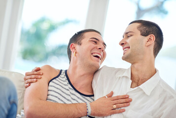 Our home is filled with love and laughter. Shot of a gay couple relaxing together at home.