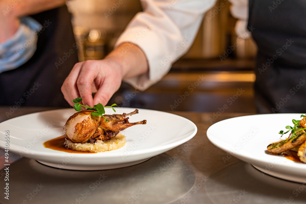 Wall mural quail plated and prepared in kitchen by chef