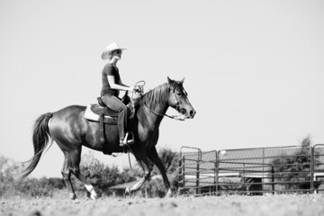 Horse gallop with cowgirl for western lifestyle in black and white on ranch.