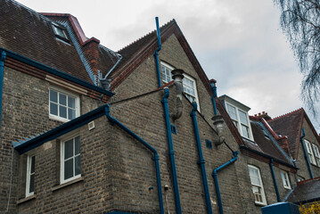 Gutters on side wall of old traditional British brick house