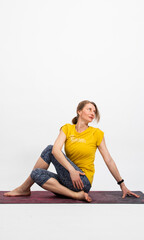 Obraz premium woman doing yoga on a white background Matsyendrasana spinal twist
