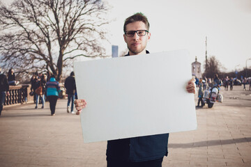 a person activist holding a cardboard copy space, template mockup for text