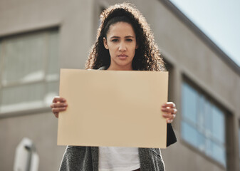 They cant take your freedom. Cropped portrait of an attractive young woman holding a sign while protesting for her rights.