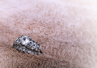 White diamond  ring on capet. Shape ring is beautifully designed to very old-style in hand on white background. Gift for marry, anniversary, valentine's Day, Birthday